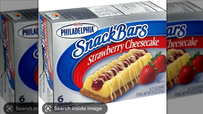 Box of Philadelphia strawberry cheesecake Snack Bars illustrated with a drizzled bar and strawberries.