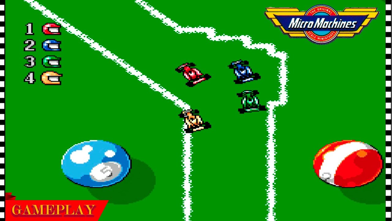 Micro Machines video game screenshot showing four tiny race cars navigating a green billiards-table circuit.