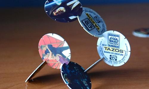 Star Wars Tazos slotted together into a freestanding chain on a tabletop.