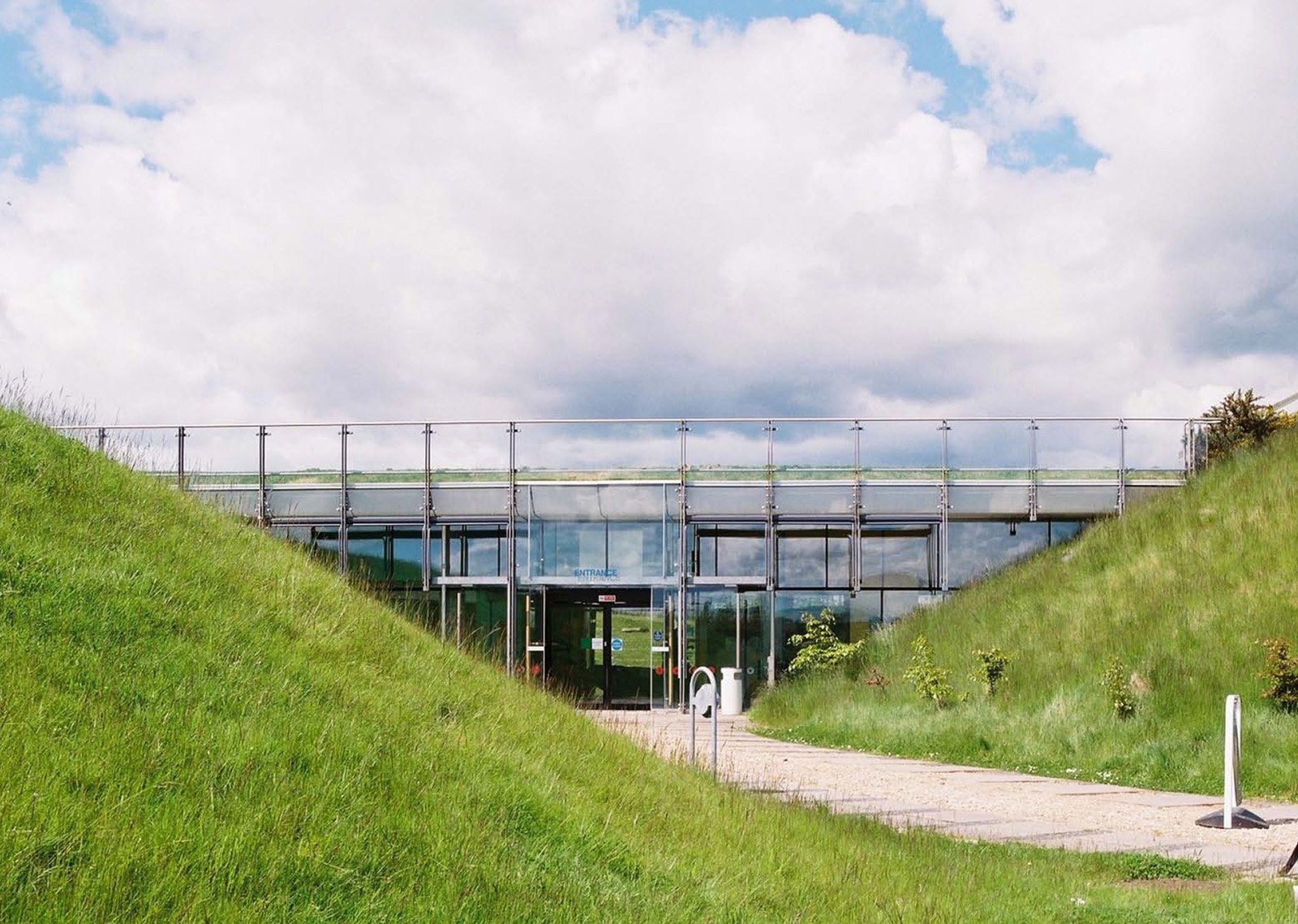 The approach between earth banks carried visitors into a centre designed to sit within, rather than dominate, its surroundings.