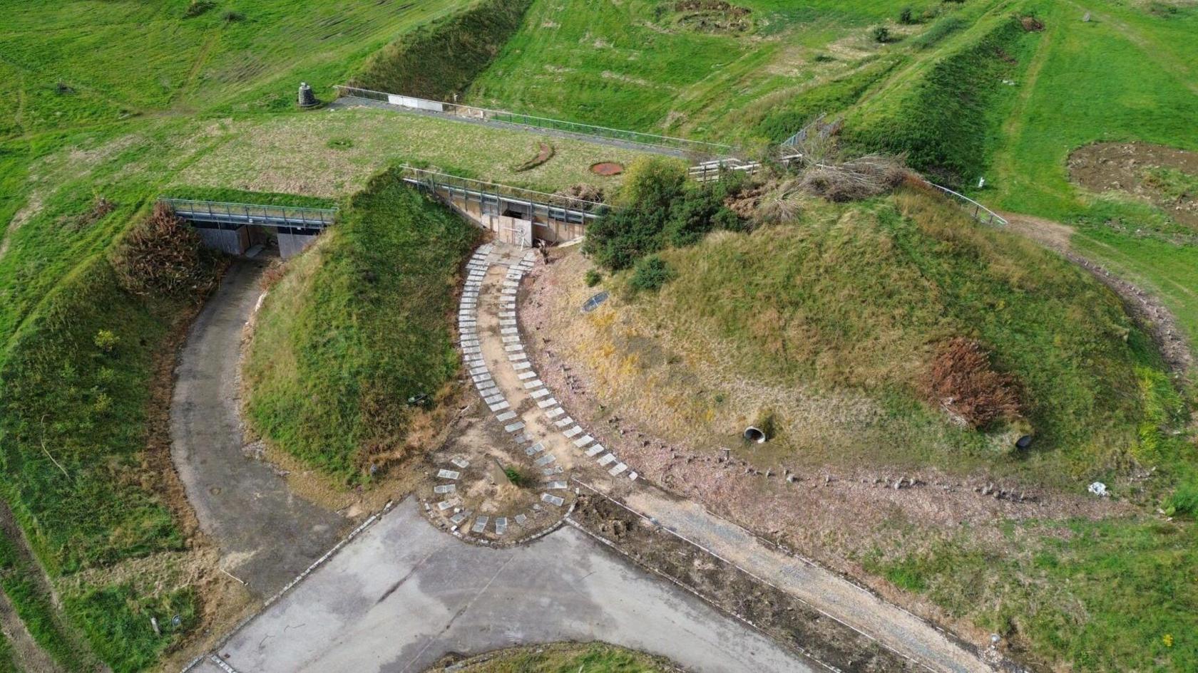 From above, the grass-covered forms reveal how deliberately Archaeolink’s architecture was folded into the site.