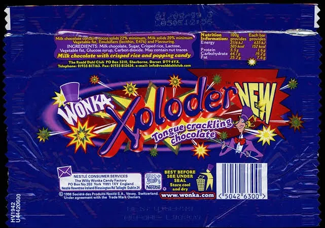 Back of a dark blue Wonka Xploder chocolate bar wrapper with a large red and yellow starburst logo, the words “Tongue crackling chocolate,” ingredient and nutrition panels, a barcode, and small cartoon figures.
