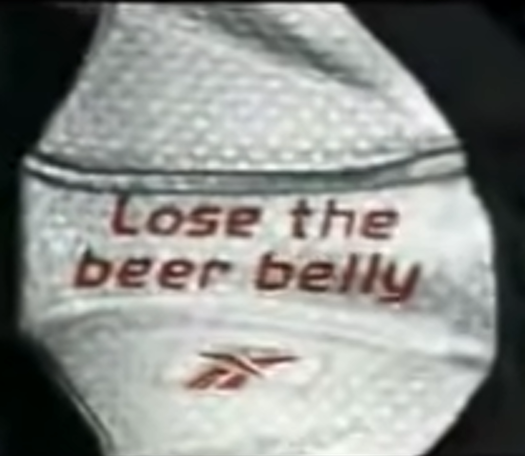 Close-up of a pale hairy belly above white briefs printed with the words "Lose the beer belly" and a Reebok logo.