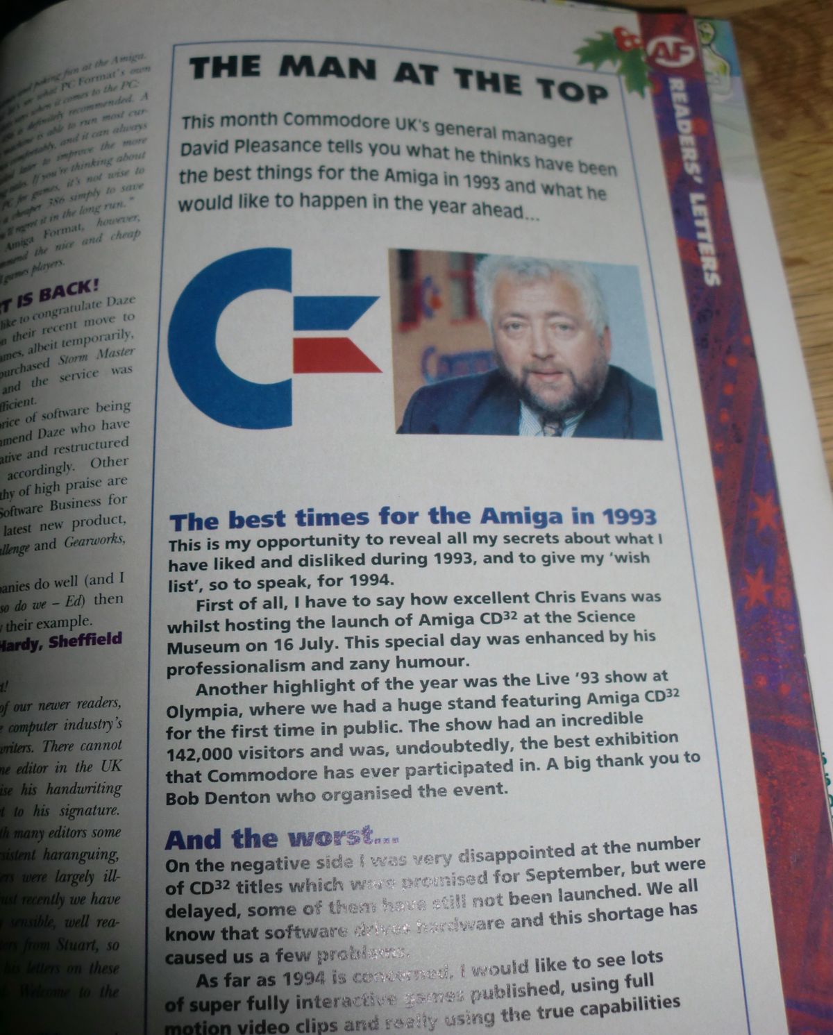 Photograph of an open magazine page headed “THE MAN AT THE TOP,” with a portrait of Commodore UK general manager David Pleasance. The visible article text mentions Chris Evans hosting the Amiga CD32 launch at the Science Museum on 16 July and a Live ’93 show display.