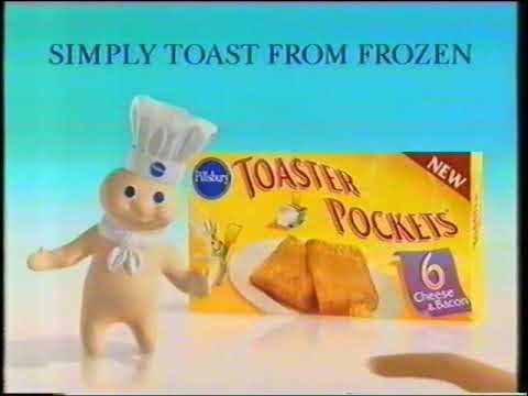 Television end card on a turquoise background with the Pillsbury Doughboy beside a yellow box labeled “Pillsbury Toaster Pockets.” Text across the top reads “SIMPLY TOAST FROM FROZEN,” and the package shows two browned triangular pockets, a red “NEW” corner label, and a purple panel marked “6.”