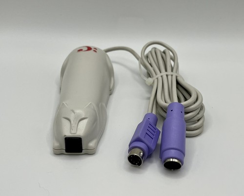 The original CueCat connected through a computer’s PS/2 keyboard connection, placing the scanner between the keyboard and PC.