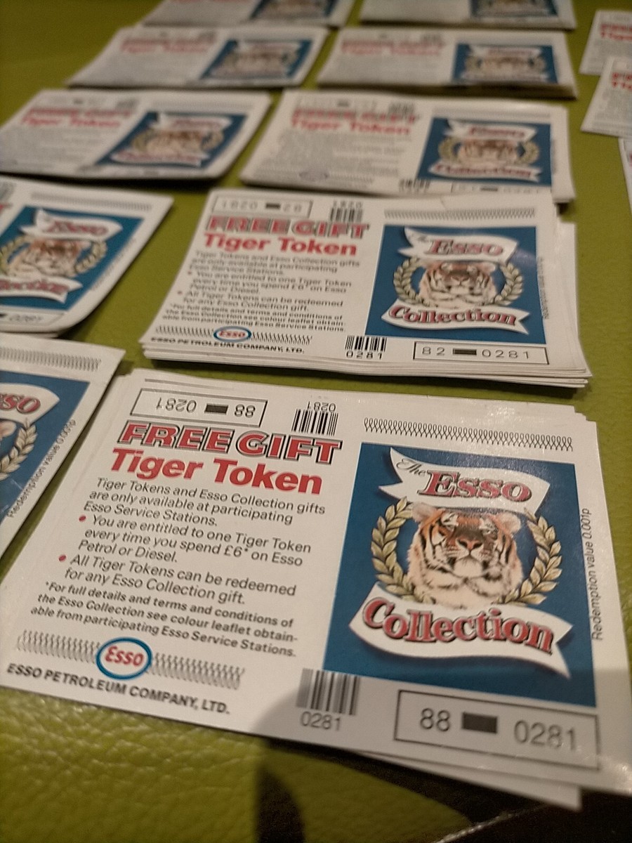 Several Esso Free Gift Tiger Token cards arranged in rows, showing tiger emblems, printed conditions and identifying numbers.