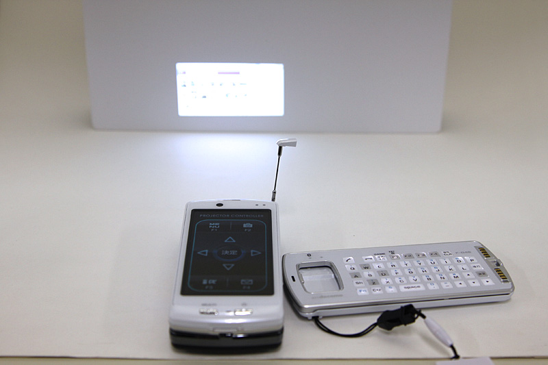 The optional Projector Unit F01 extended the F-04B beyond conventional phone use, allowing images and video to be projected onto nearby surfaces.