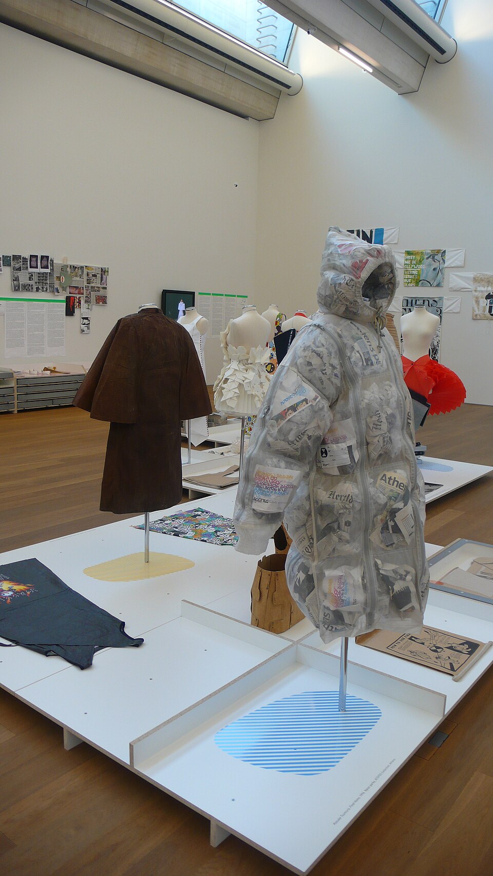 Newspaper became part of the garment. This museum display makes FINAL HOME’s unusual approach to insulation visible through the nylon shell.