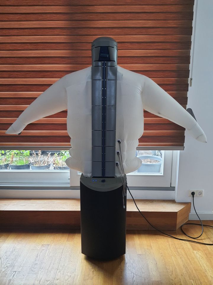 The shirt went on the machine as if it were being dressed. Getting it fastened and positioned was part of the job, even when hot air did the smoothing.