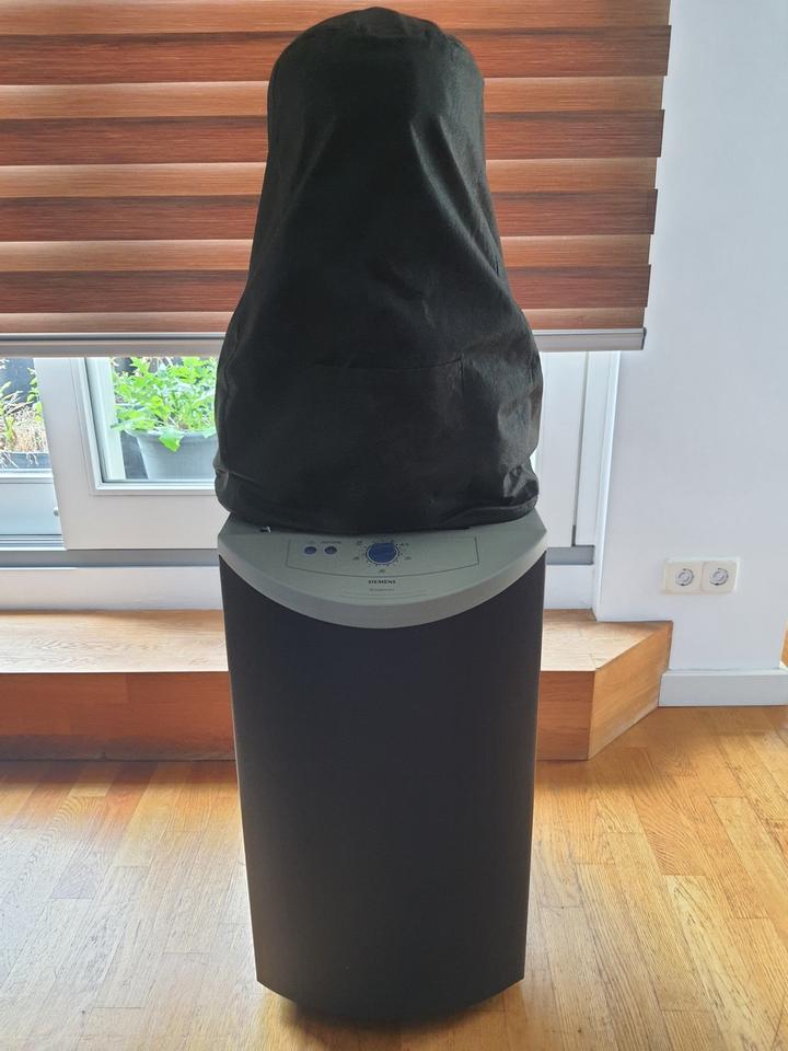 When the shirts were finished, the torso packed down under a cover. The space-saving trick mattered for an appliance that otherwise stood like another person in the room.