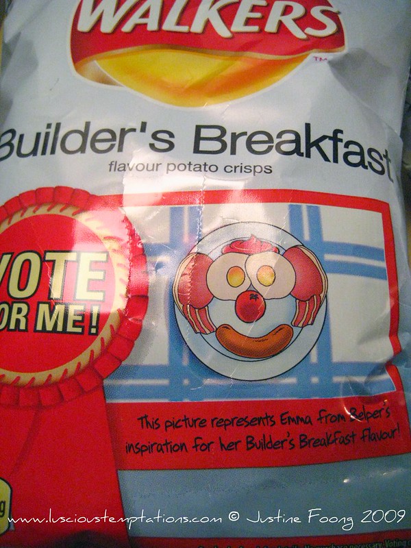 Close view of a pale blue Walkers Builder’s Breakfast packet with a red Vote For Me rosette and a cartoon breakfast face made from eggs, bacon and a sausage.