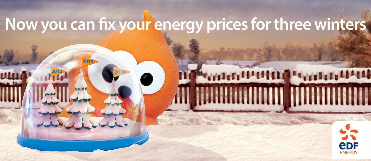 An orange rounded character with large white eyes peers around a snowglobe containing three snowy trees flagged2012,2013and2014. Snow and a wooden fence fill the background, with a fixed-energy-price headline above and the EDF Energy logo at lower right.