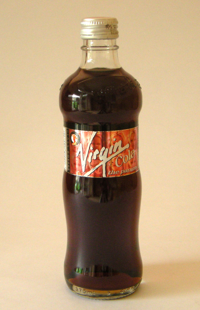 A sealed dark-cola bottle with a contoured waist, gold-coloured screw cap, red Virgin Cola label reading “the pammy,” and a 375 ml marking near the base.