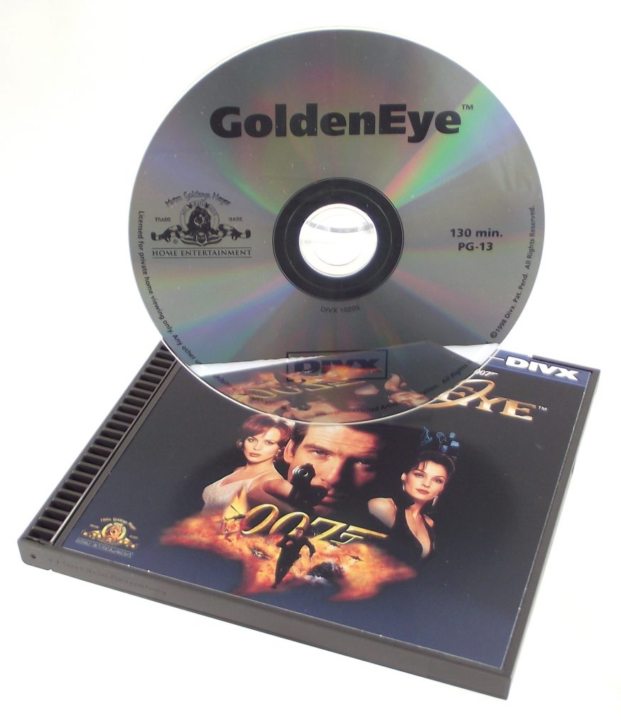 A silver GoldenEye DIVX disc stands upright behind its matching film package. The photograph is hosted by the Museum of Obsolete Media; its capture date and individual photographer are not stated. It depicts the physical DIVX format, not a period advertisement.