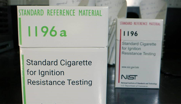 Laboratory cigarette cartons labelled SRM1196a in the foreground and SRM1196 in the background.