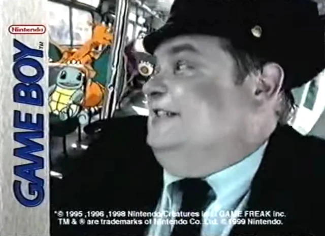 A yellow bus filled with Pokémon characters approaches a crusher; the Game Boy logo appears across the top of the frame.