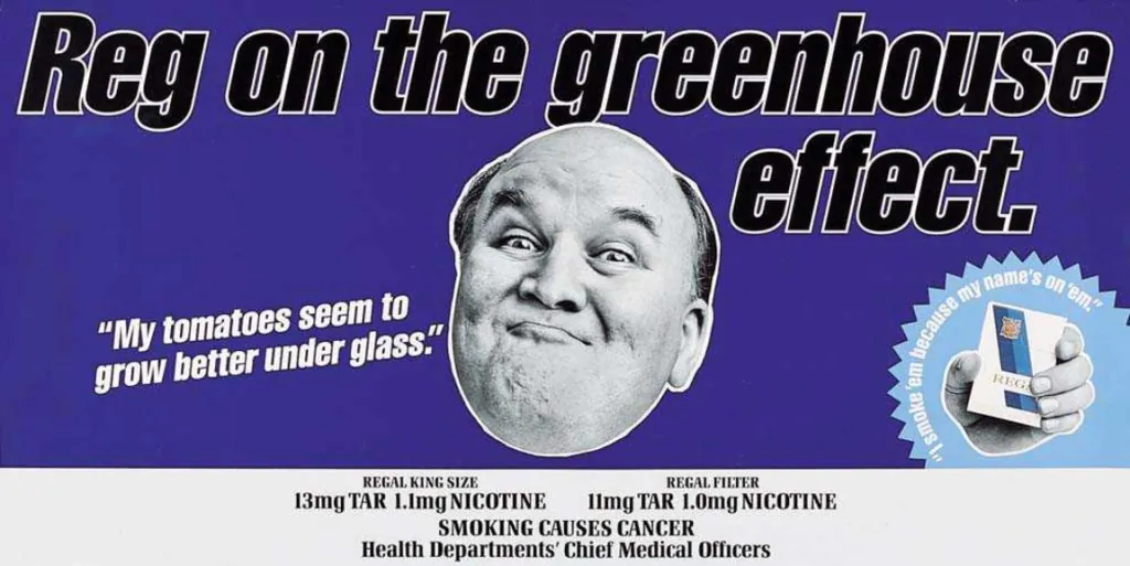 Purple Embassy Regal cigarette advert headed “Reg on the greenhouse effect.” A black-and-white cut-out portrait of Reg appears beside the line “My tomatoes seem to grow better under glass.” and a hand holding a Regal pack. Tar, nicotine and smoking warning text runs along the bottom.