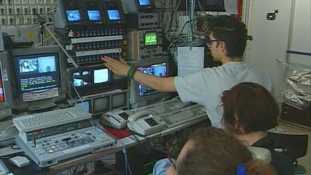 Operators work among monitors, video equipment and control panels in the Piazza Virtuale control room.