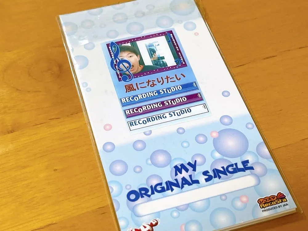 Blue-and-white RECOSTA CD sleeve with bubble graphics, a personalised cover photograph and the words “My Original Single”.