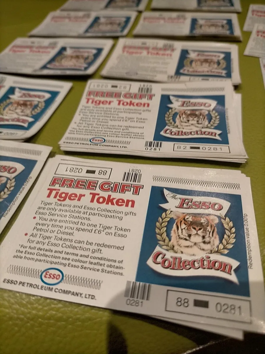 Several Esso Free Gift Tiger Token cards arranged in rows, showing tiger emblems, printed conditions and identifying numbers.