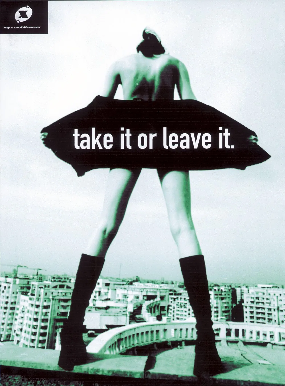 Green-tinted MY X Mobilewear outdoor advertisement showing a figure holding out a black garment above a cityscape, with the words ‘take it or leave it.’