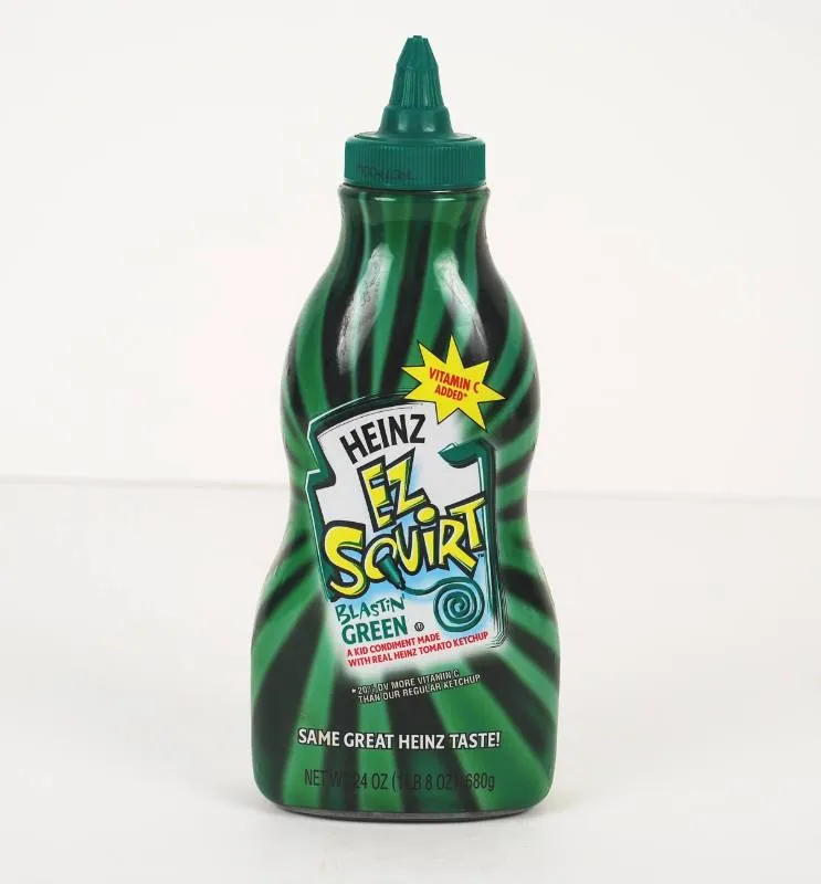 Front-facing green Heinz EZ Squirt squeeze bottle with a pointed cap, dark wavy stripes, and a label reading “Blastin’ Green,” photographed against a plain off-white background.